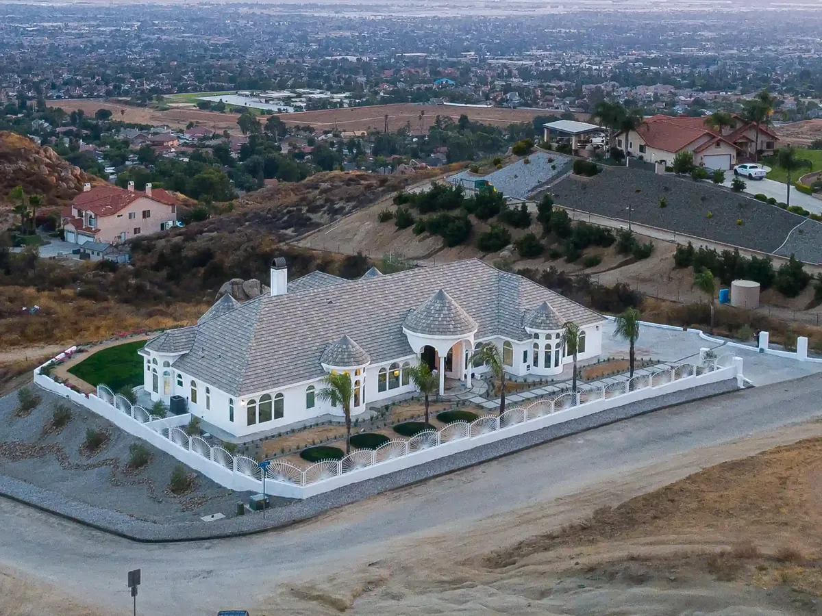 Home with a tile roof on a hillside above the valley, seen from the air