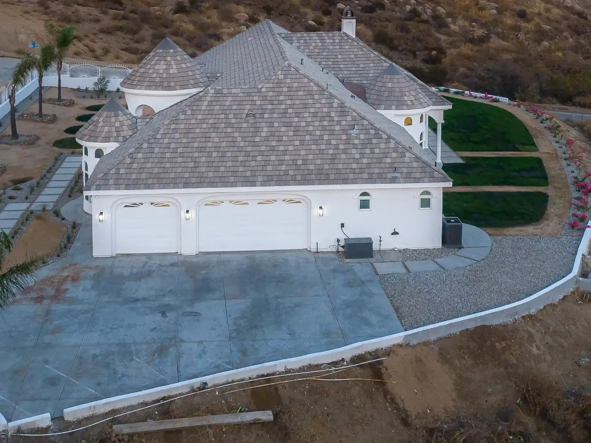 Tile roof with hips and ridges above a three-car garage